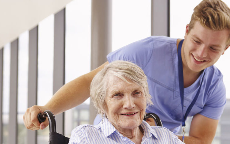 hero-about-medical-worker-pushing-wheelchair-with-elderly-person-in-it